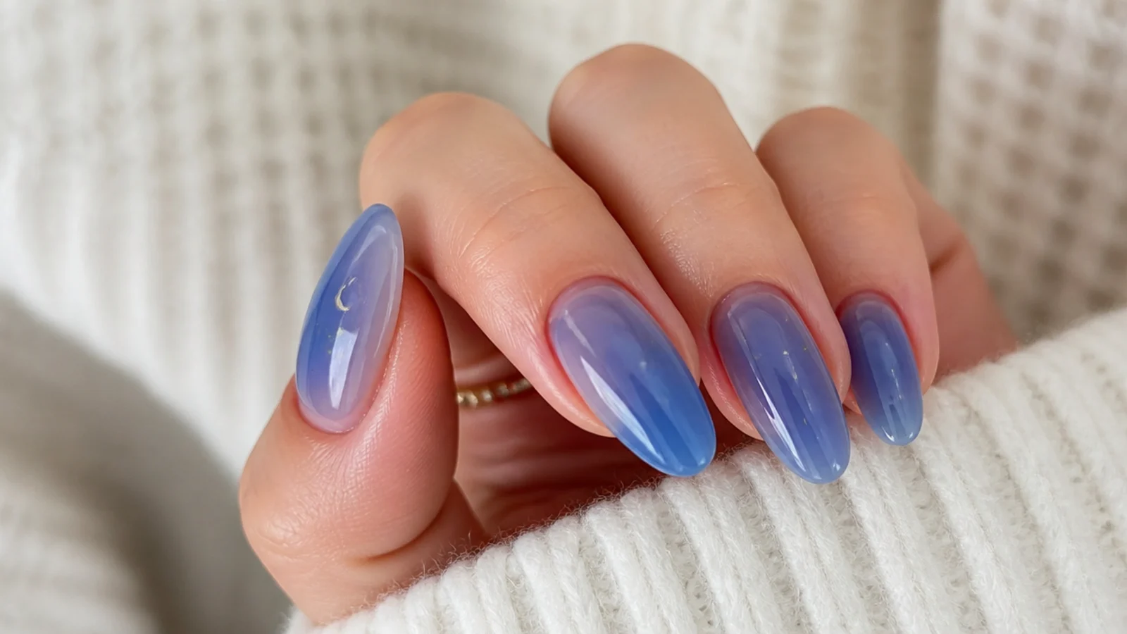 Milky sheer royal blue almond nails with a soft translucent wash