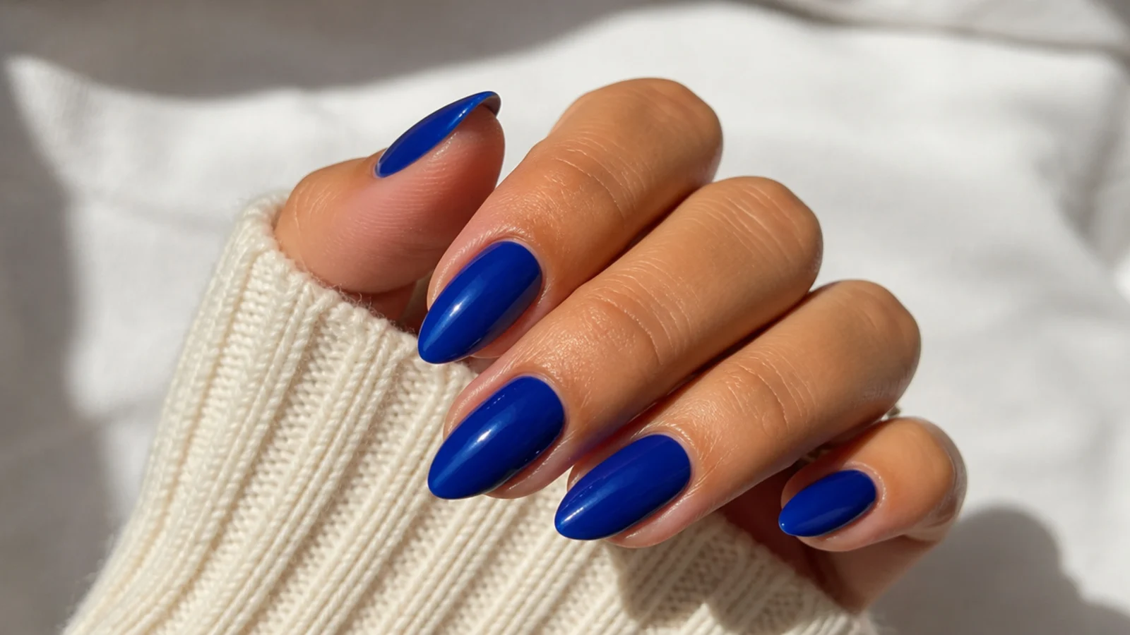 Smooth royal blue creme almond nails with a clean opaque finish