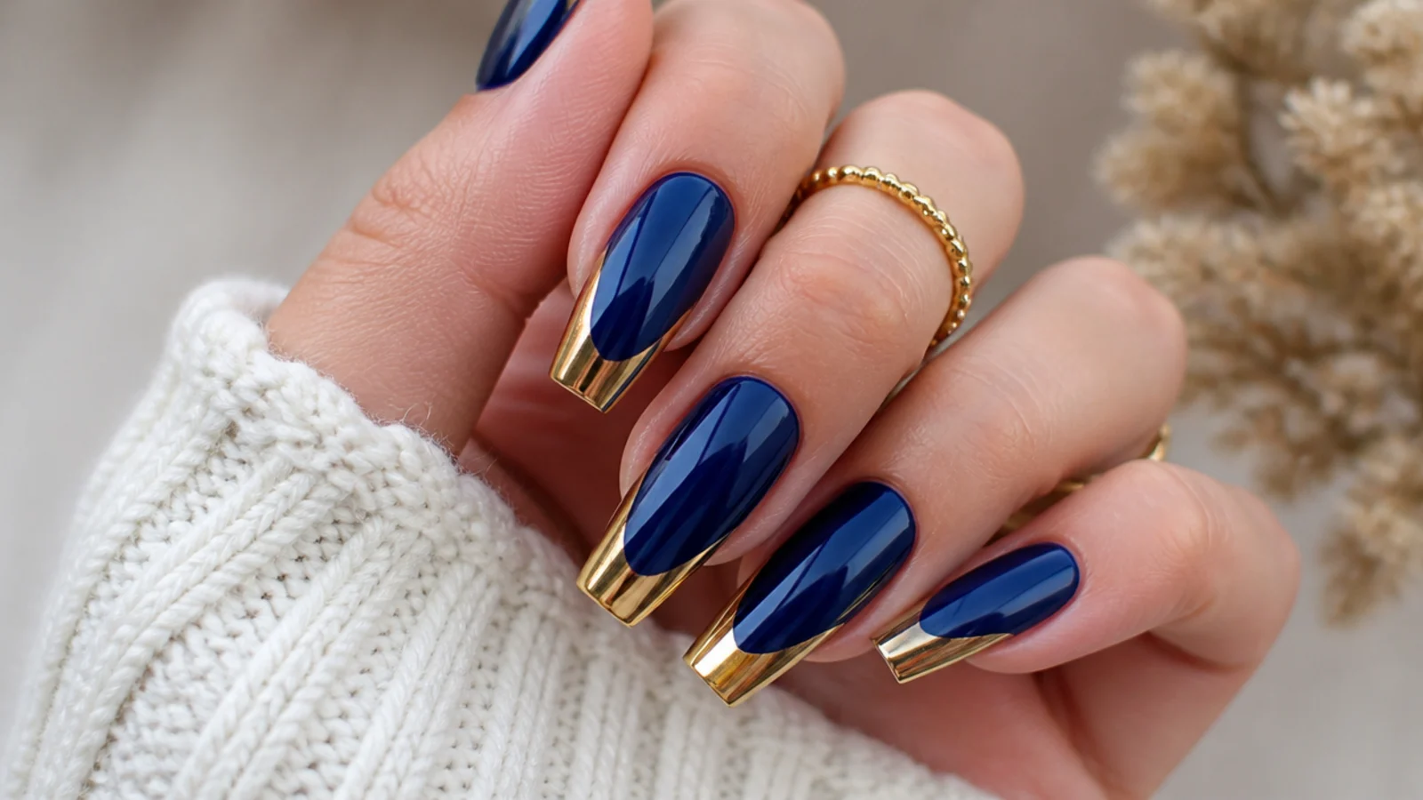Royal blue nails with mirror gold chrome tips on a coffin shape