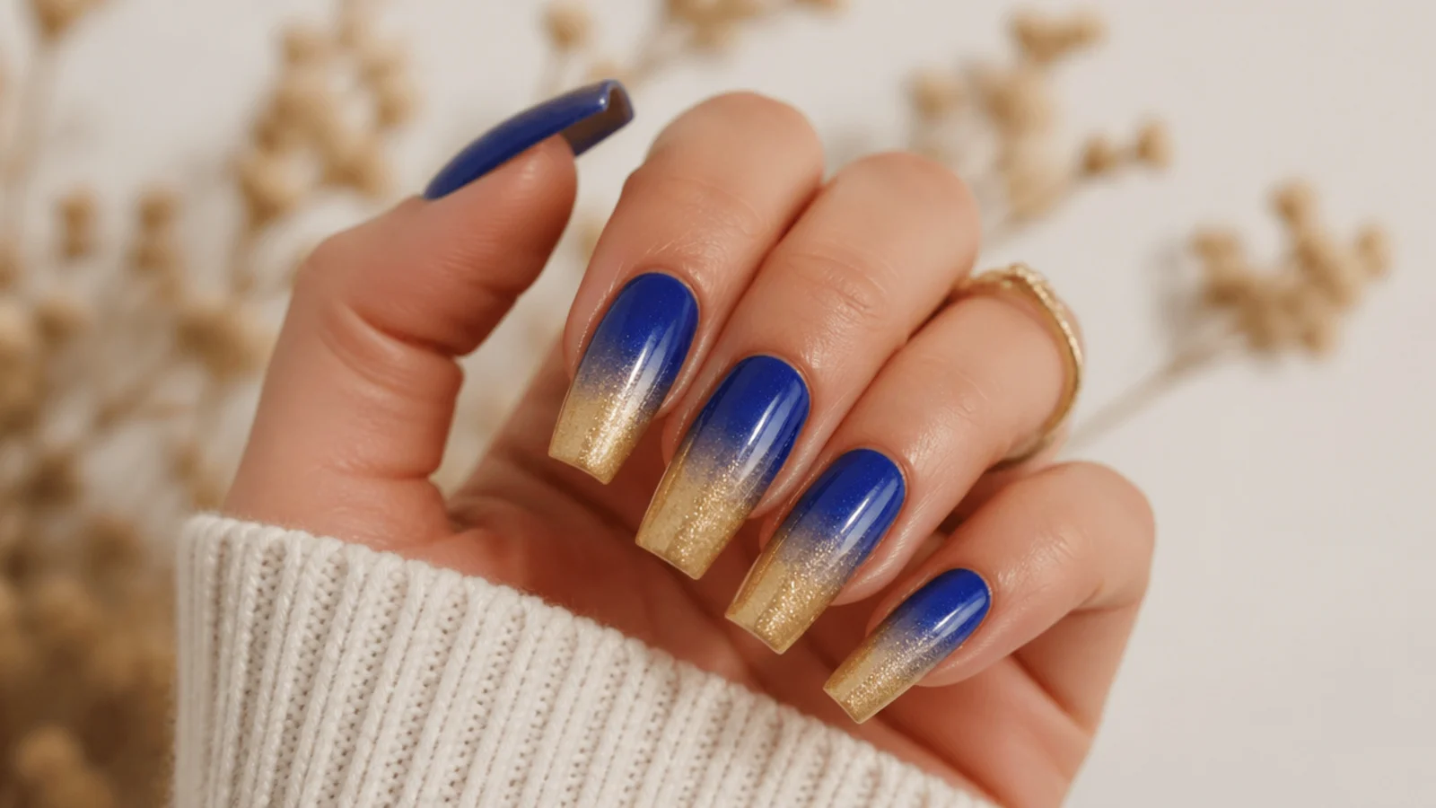 Royal blue fading into warm gold ombre across coffin nails