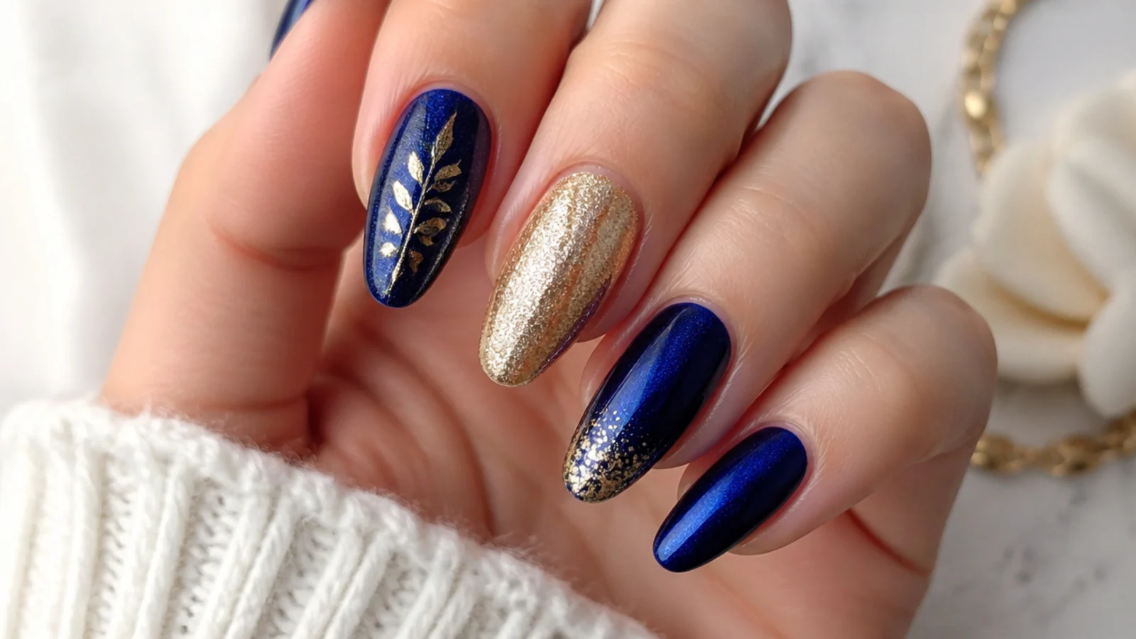 Royal blue and gold nails styled for prom, wedding and everyday looks