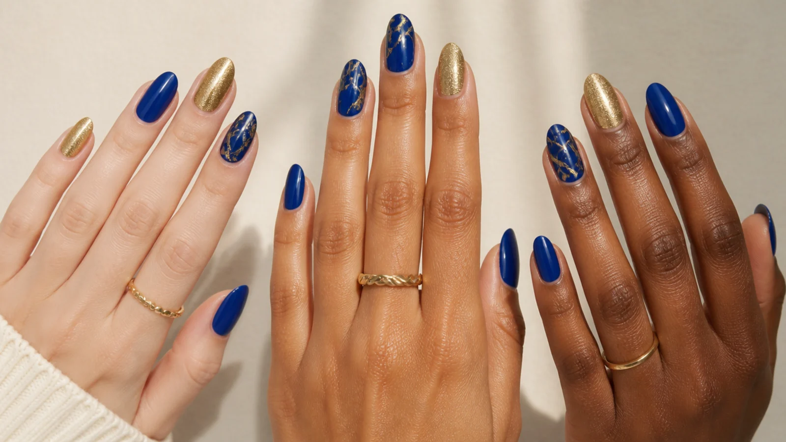 Royal blue and gold nails shown against fair, medium and deep skin tones