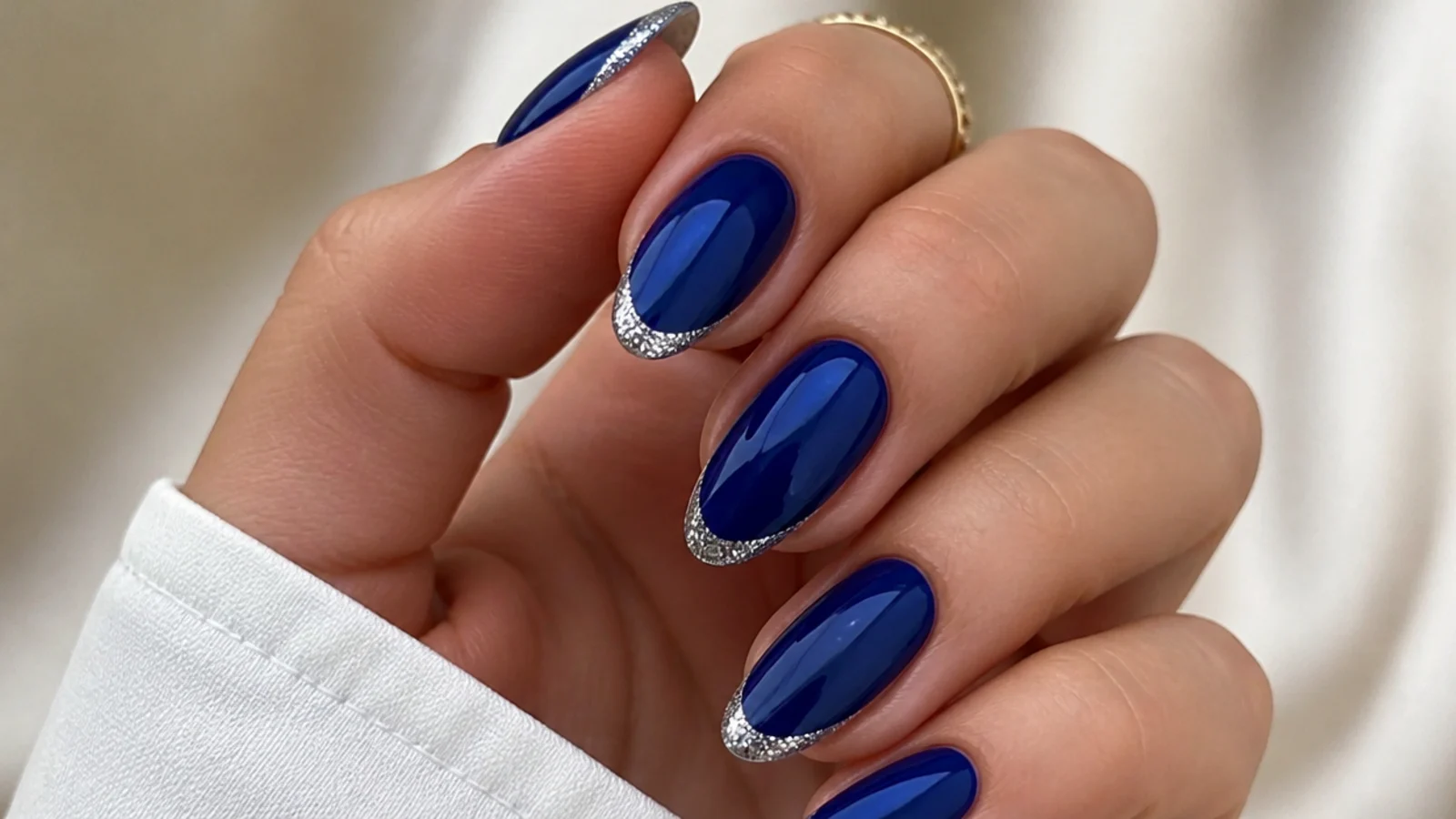 Royal blue nails with fine silver glitter French tips