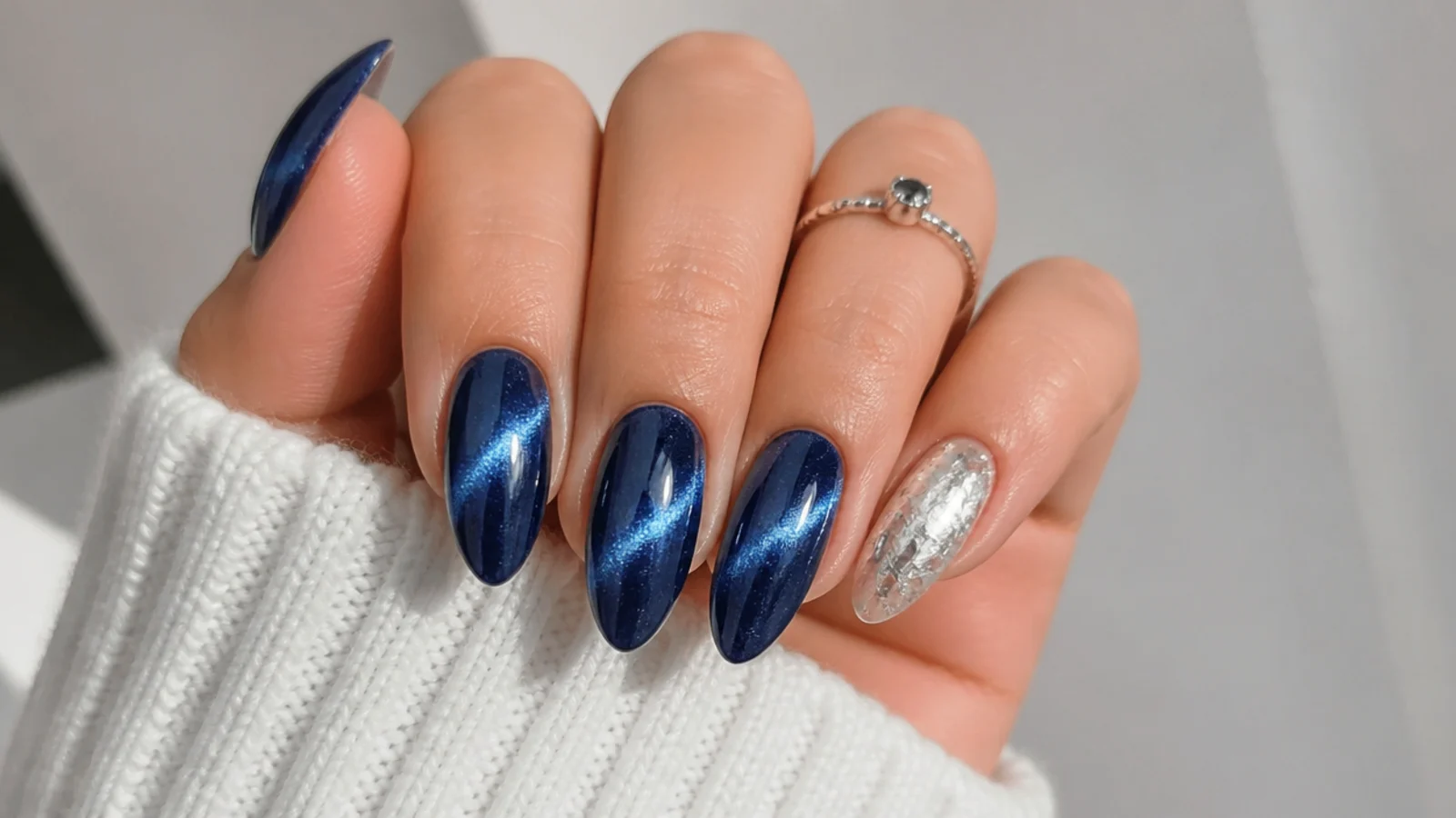 Royal blue magnetic cat-eye nails with a silver foil accent nail