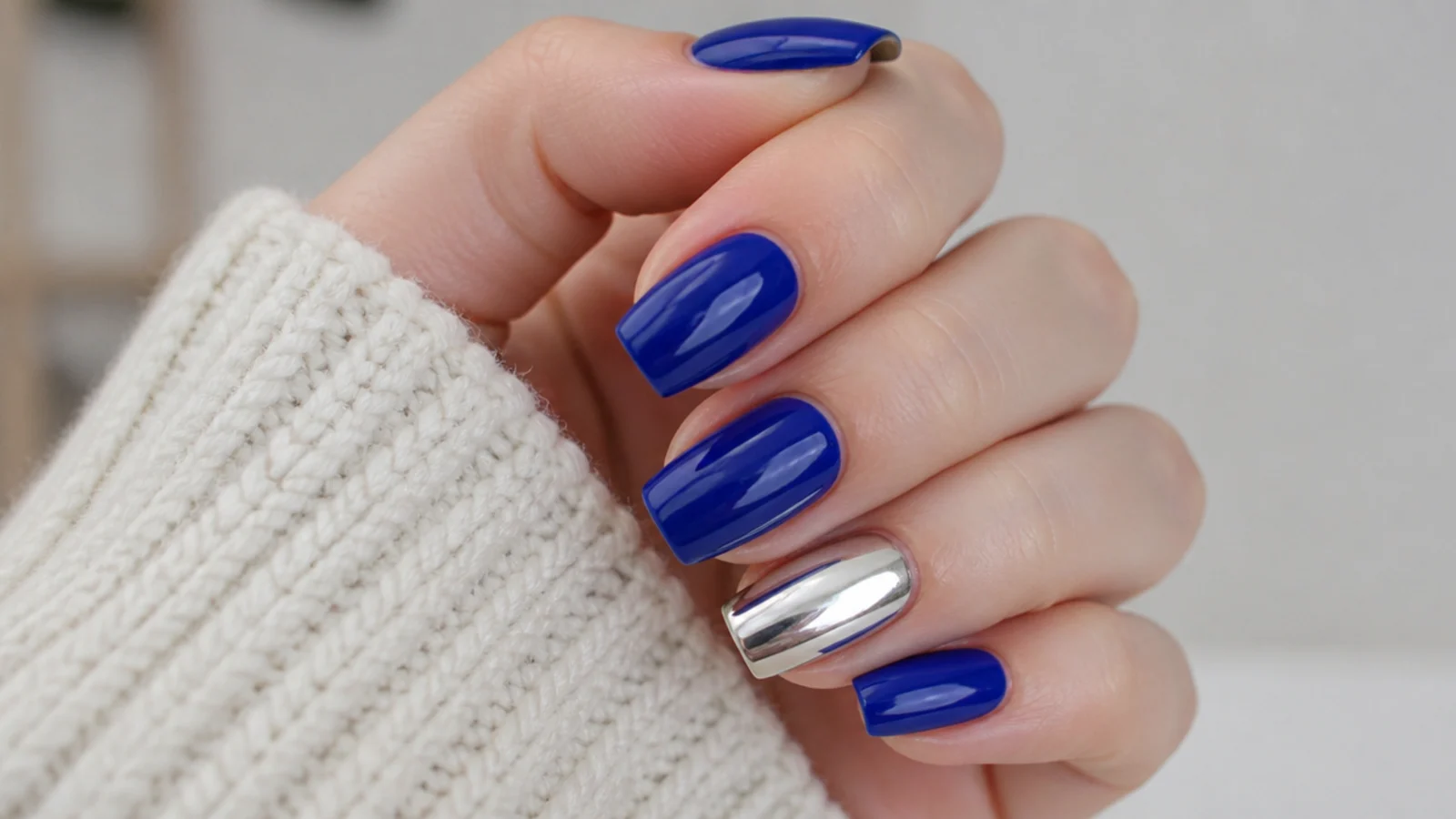 Glossy royal blue nails with one full silver mirror chrome accent nail