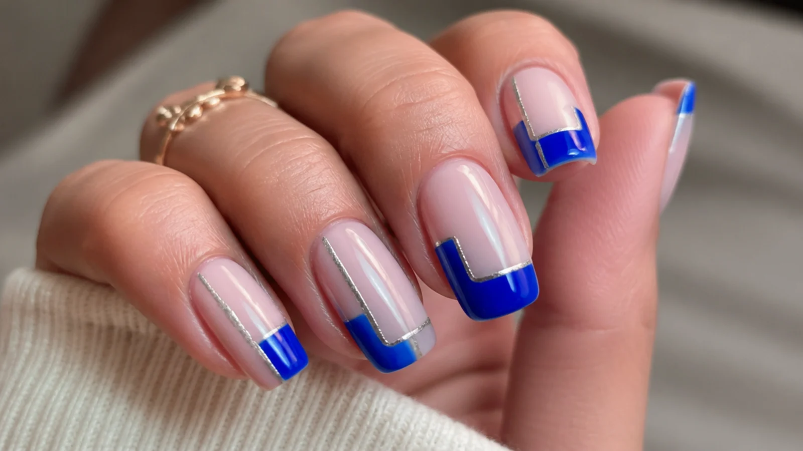 Sheer nails with royal blue blocks and thin silver line details