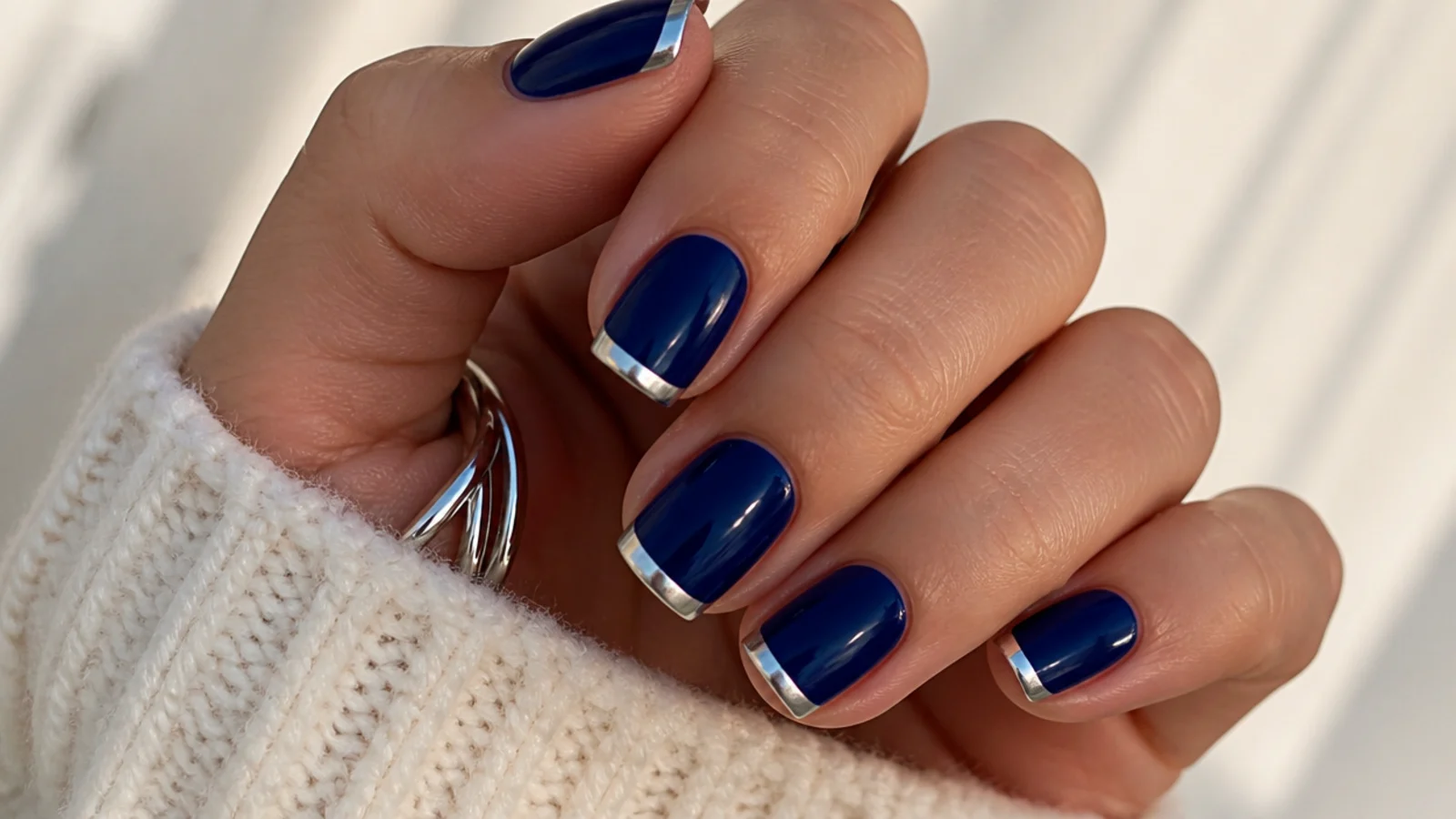 Short royal blue nails with clean silver chrome tips