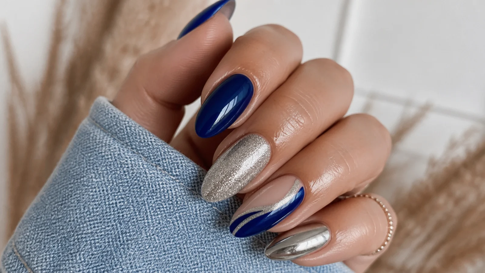 A well-sealed royal blue and silver chrome manicure with cuticle oil