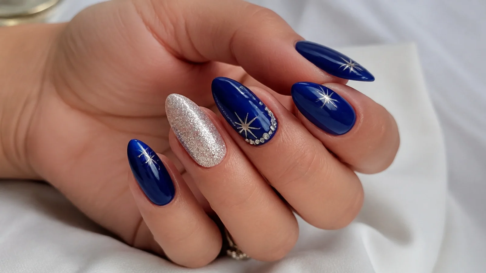Royal blue and silver nails styled for prom, a wedding and New Year