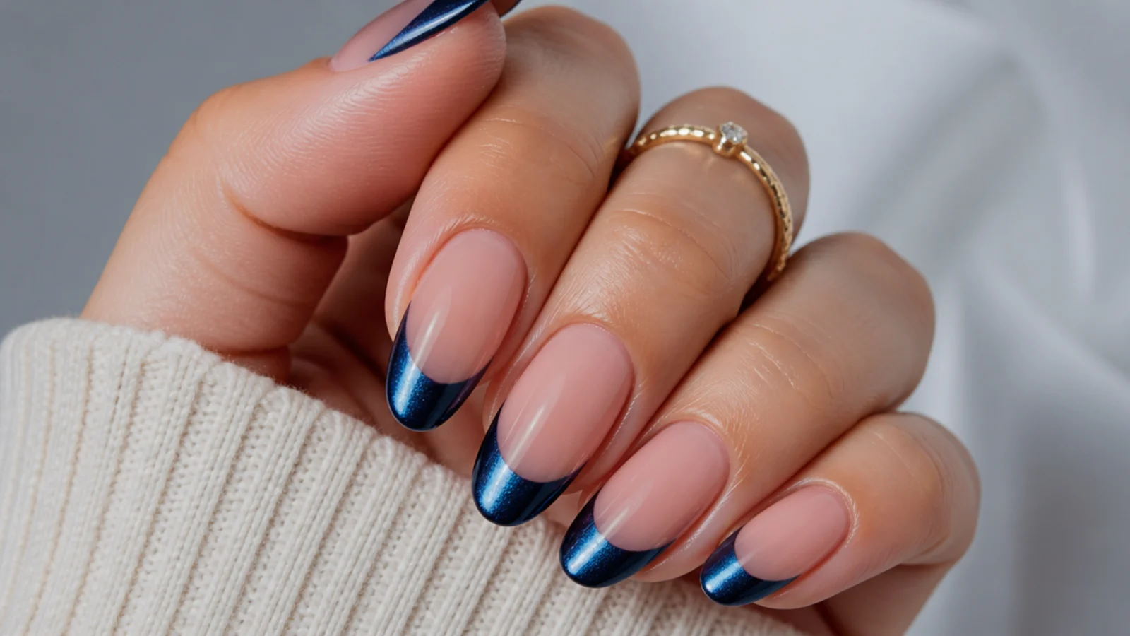 Nude royal blue nails with a cat eye magnetic french tip on each nail