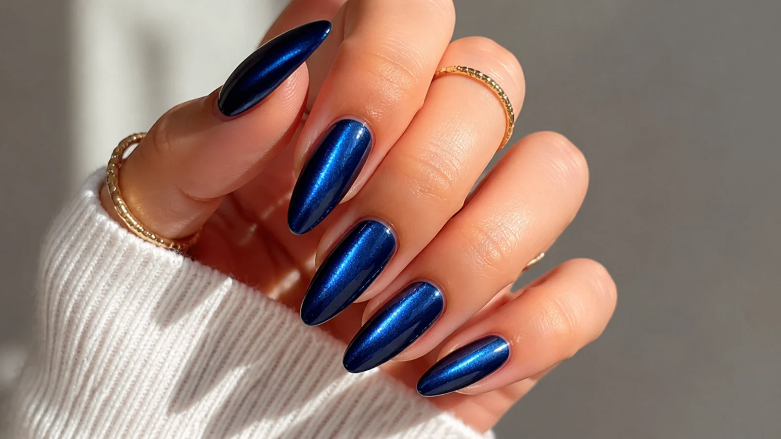 Mirror-chrome royal blue cat eye nails with a bright metallic light strip