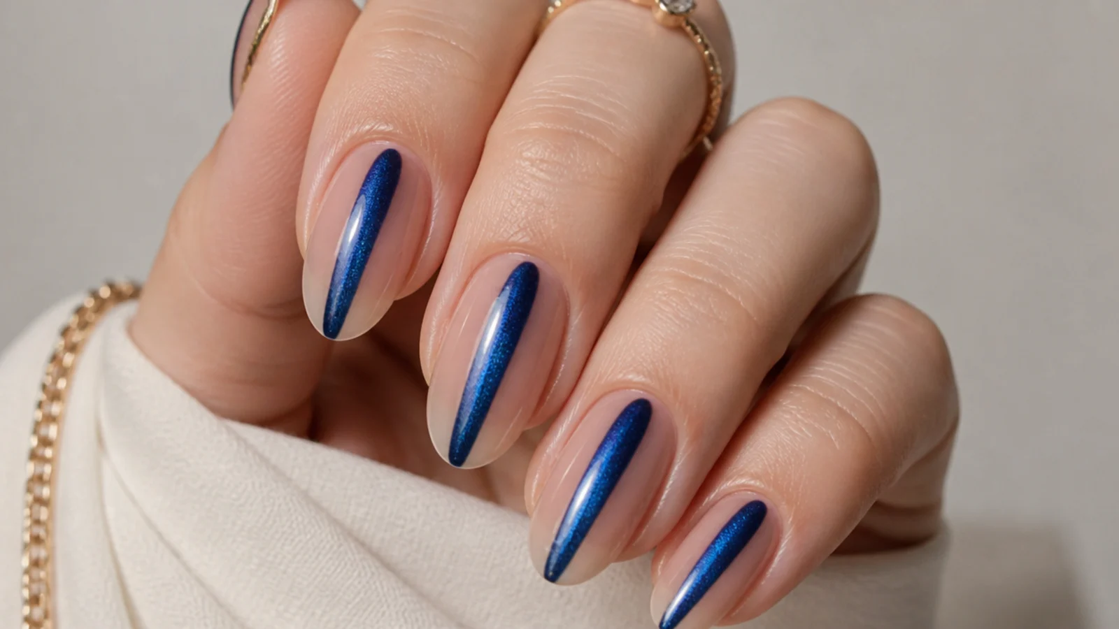 Clear nails with a royal blue cat eye stripe down the center over bare nail