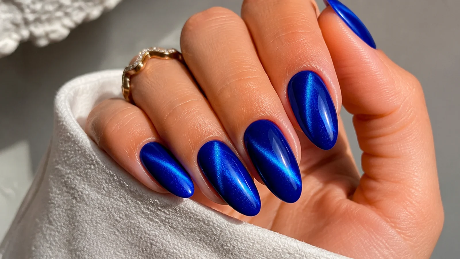 Deep true cobalt royal blue cat eye nails on a long almond shape