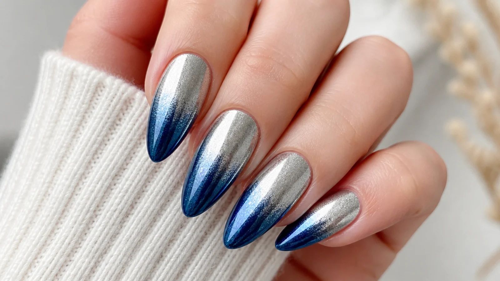 Chrome ombre nails fading from silver at the cuticle to royal blue at the tip