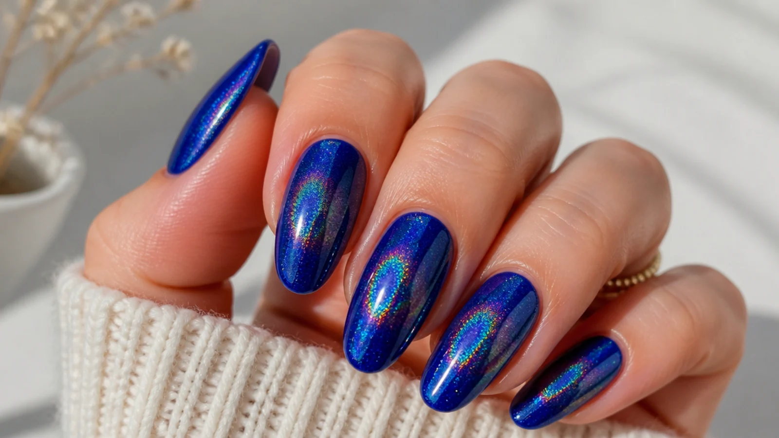 Royal blue chrome nails with a rainbow holographic sparkle in the light