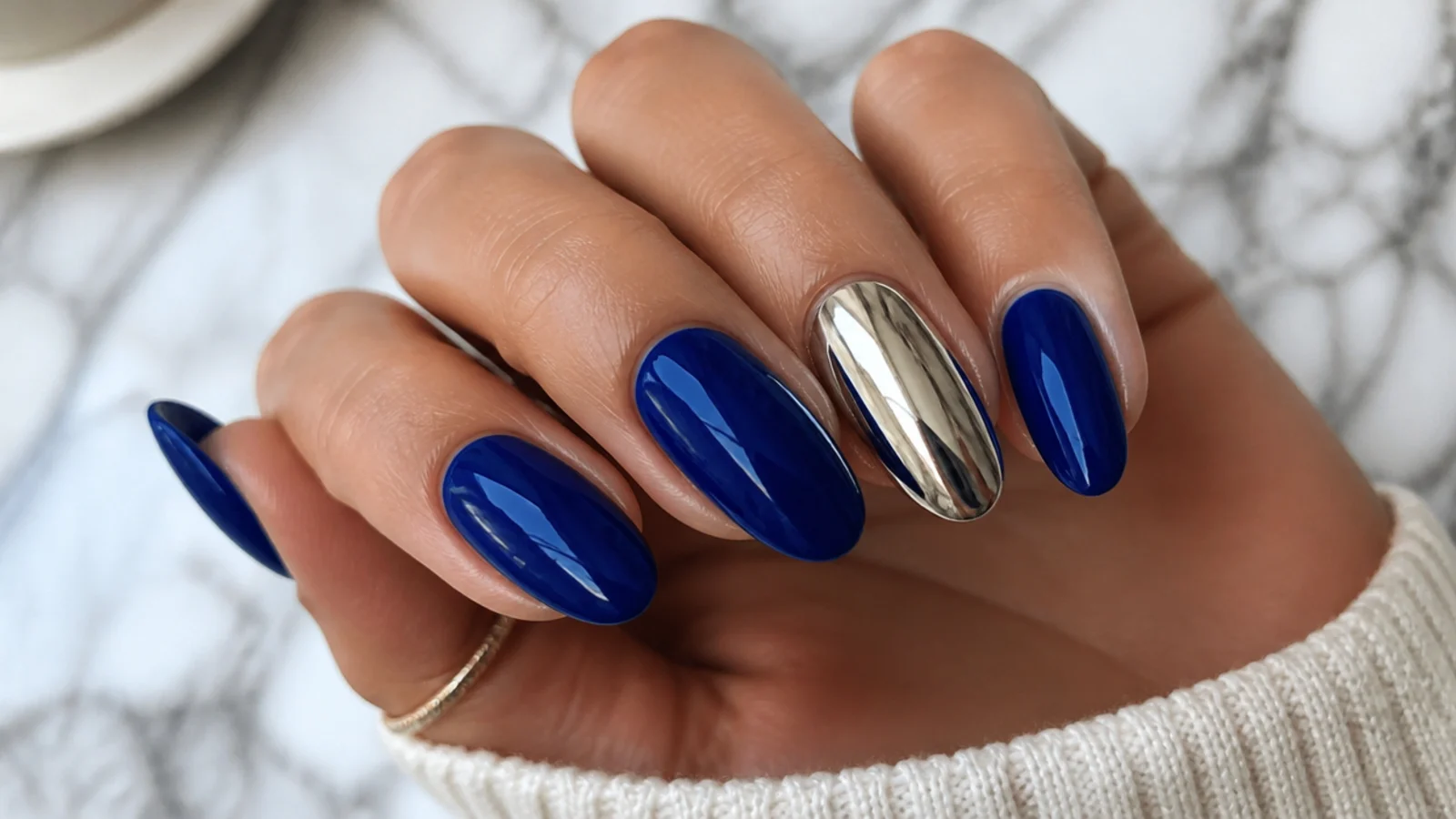 Glossy royal blue nails with one mirror chrome accent nail