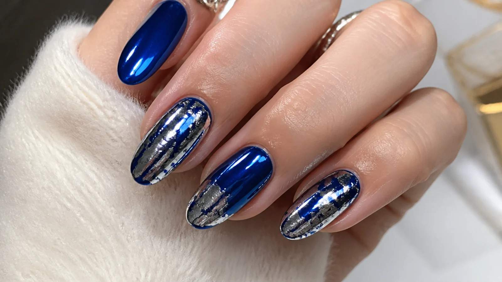 Royal blue chrome nails with crackled silver foil accents