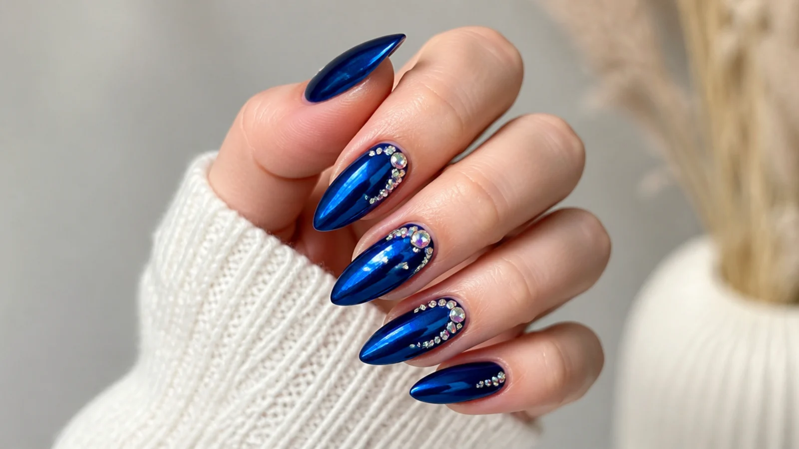 Long almond royal blue chrome prom nails with crystal accents