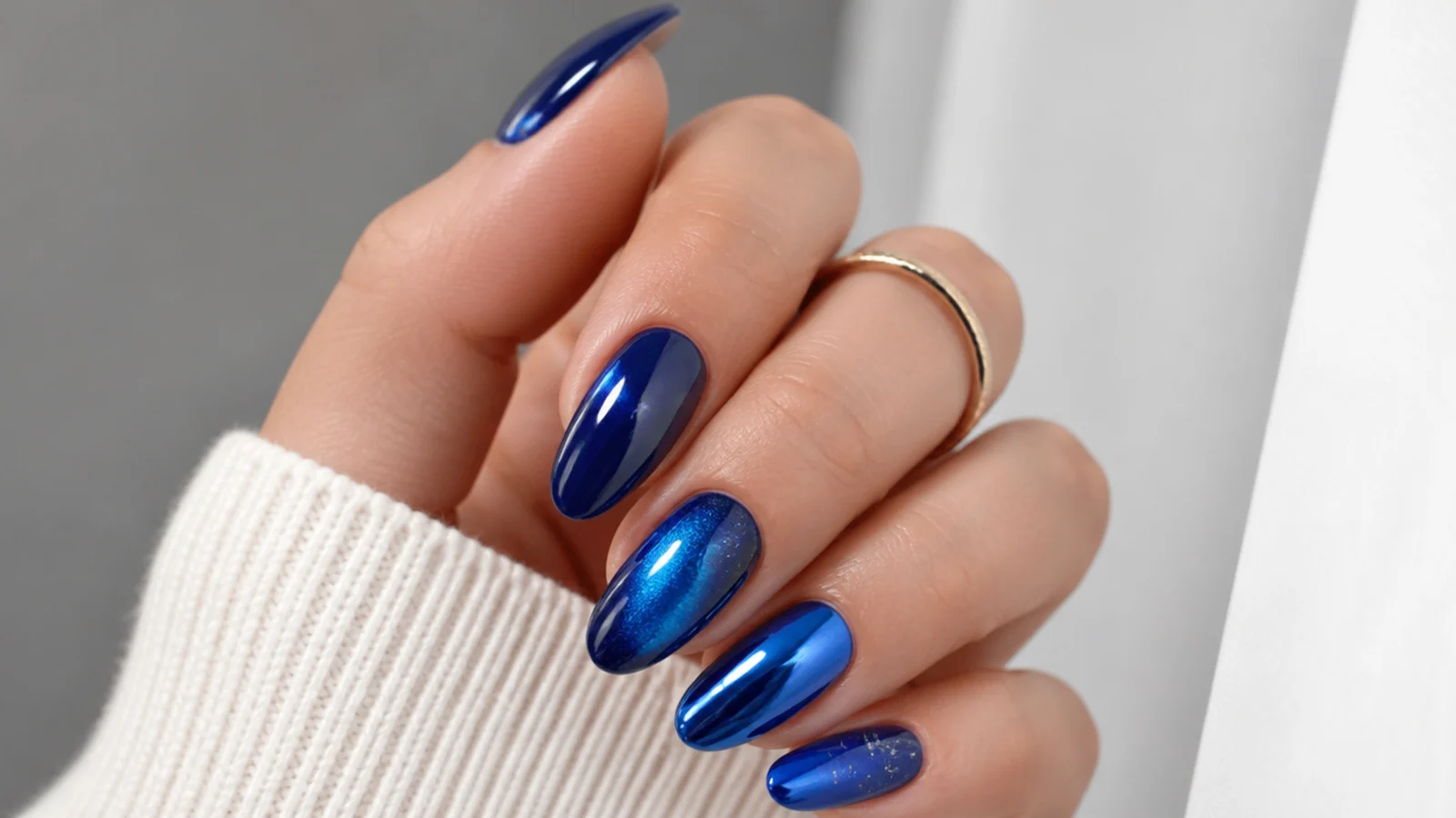 Royal blue nails shown in glossy, chrome, cat-eye and jelly finishes