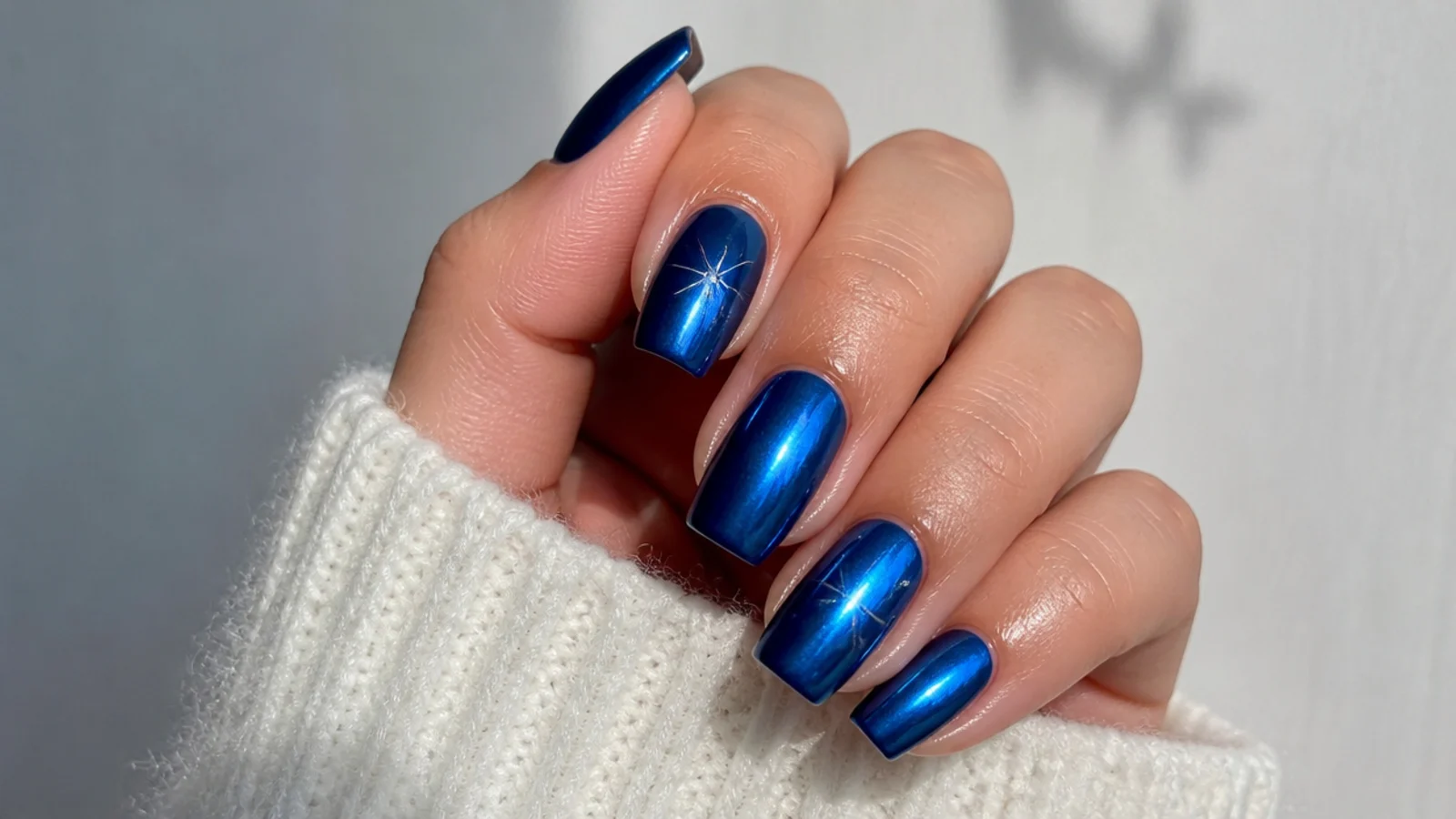 A well-sealed royal blue chrome manicure with cuticle oil for longevity