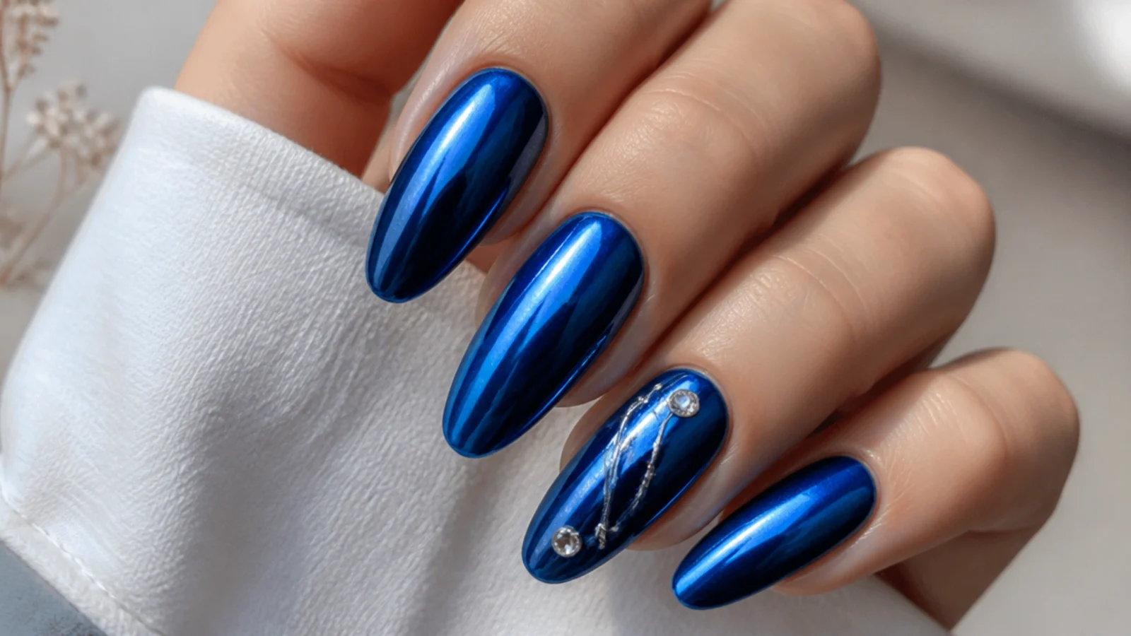 Royal blue chrome nails styled for prom, a wedding and everyday wear