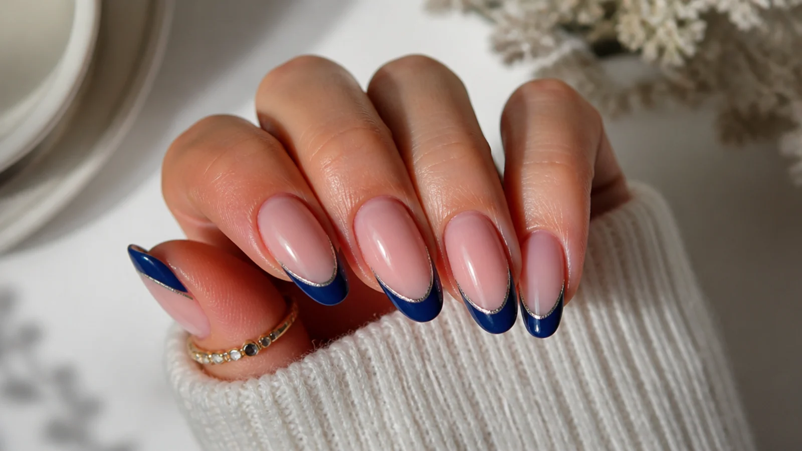 Royal blue french tips with a silver chrome line on cool nude nails