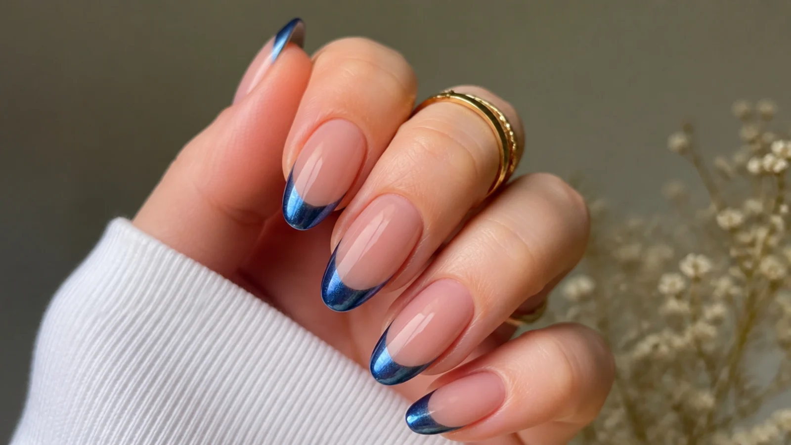 Royal blue french tips with a magnetic cat-eye light streak on nude nails