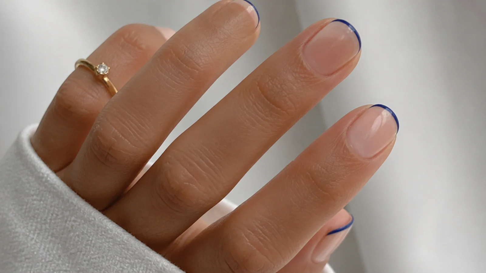 Very thin royal blue micro french tips on short natural nails