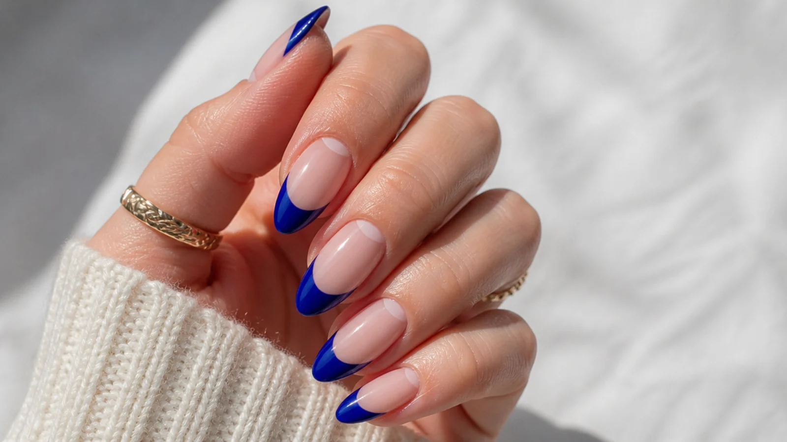 Royal blue french tips with a bare negative-space gap near the cuticle