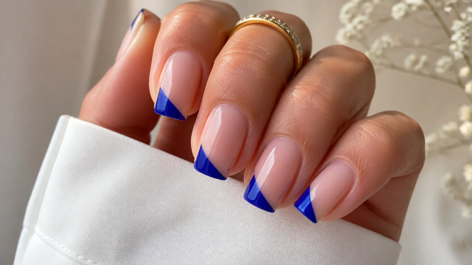 Royal blue slanted diagonal french tips on squoval nails