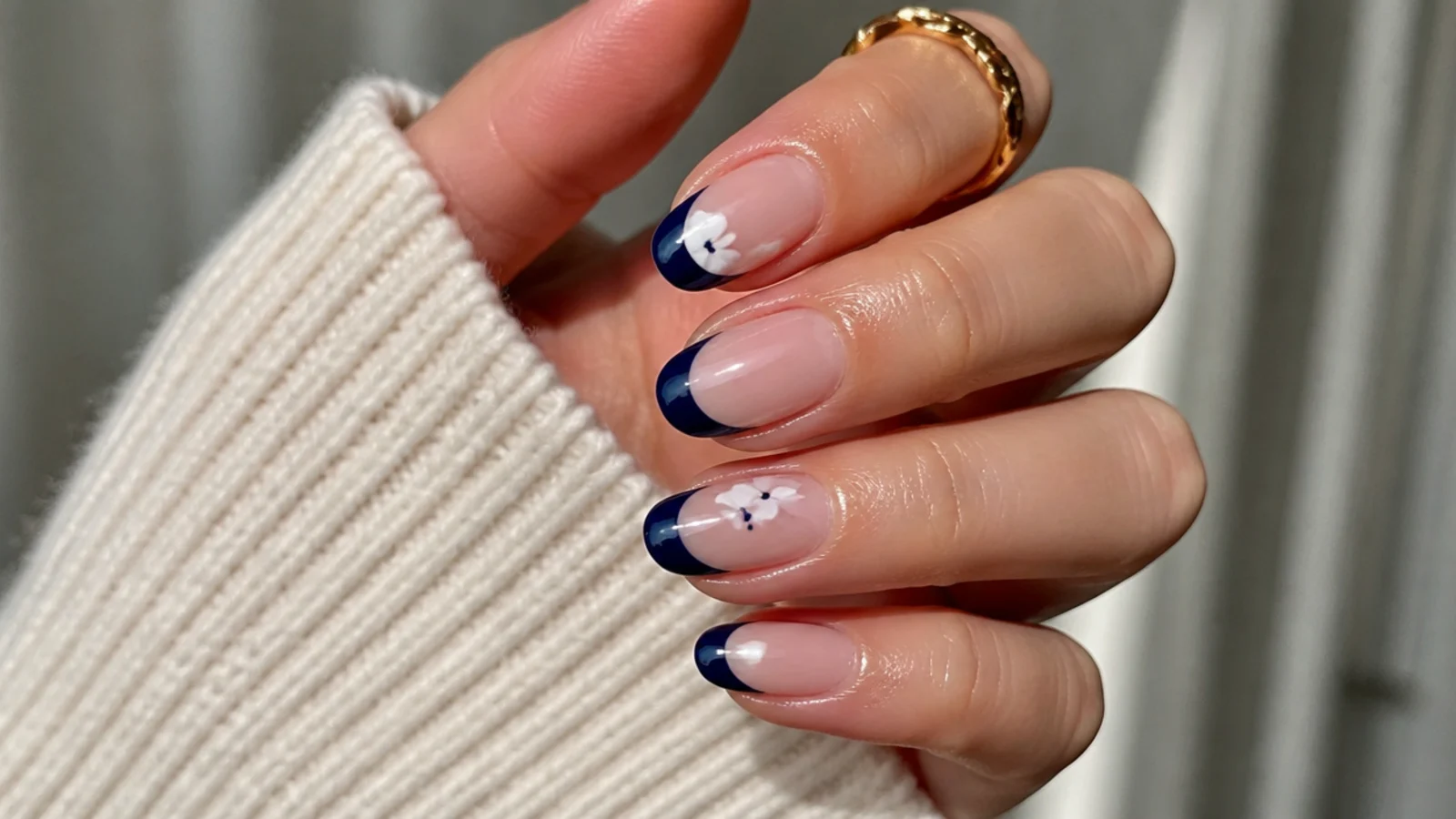 A sealed royal blue french tip manicure with cuticle oil for longevity