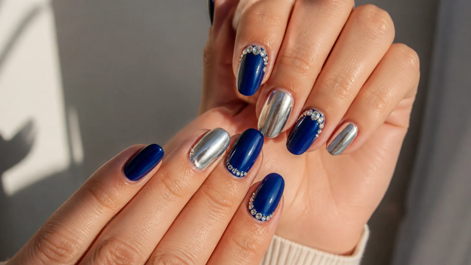 Royal blue nails with silver chrome accent nails and rhinestones