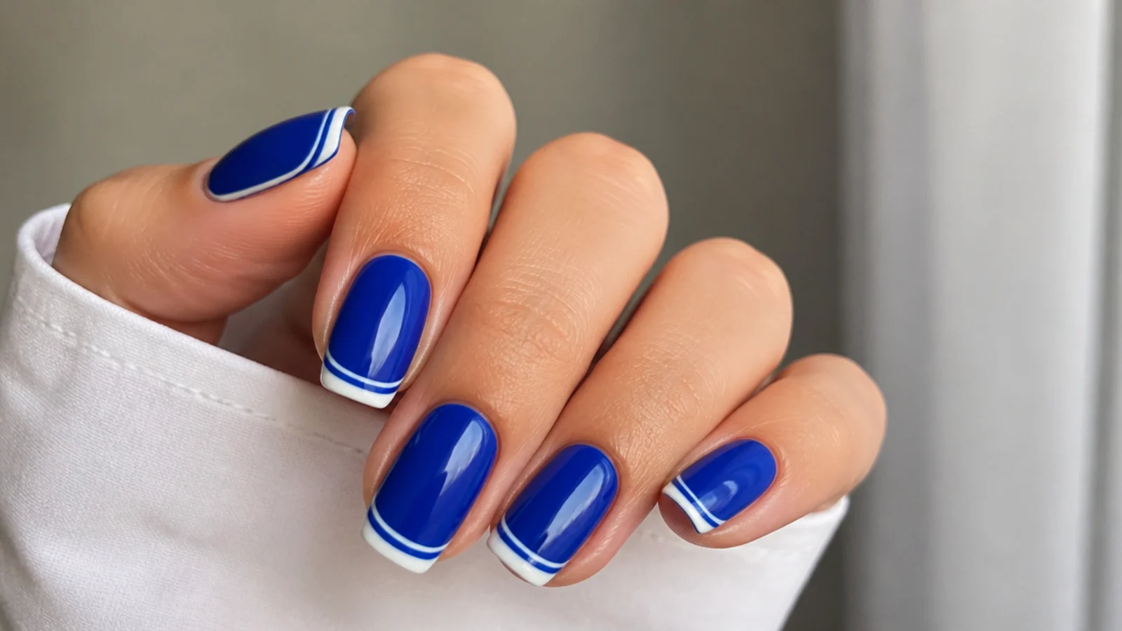 Royal blue nails with a double white and blue french tip line