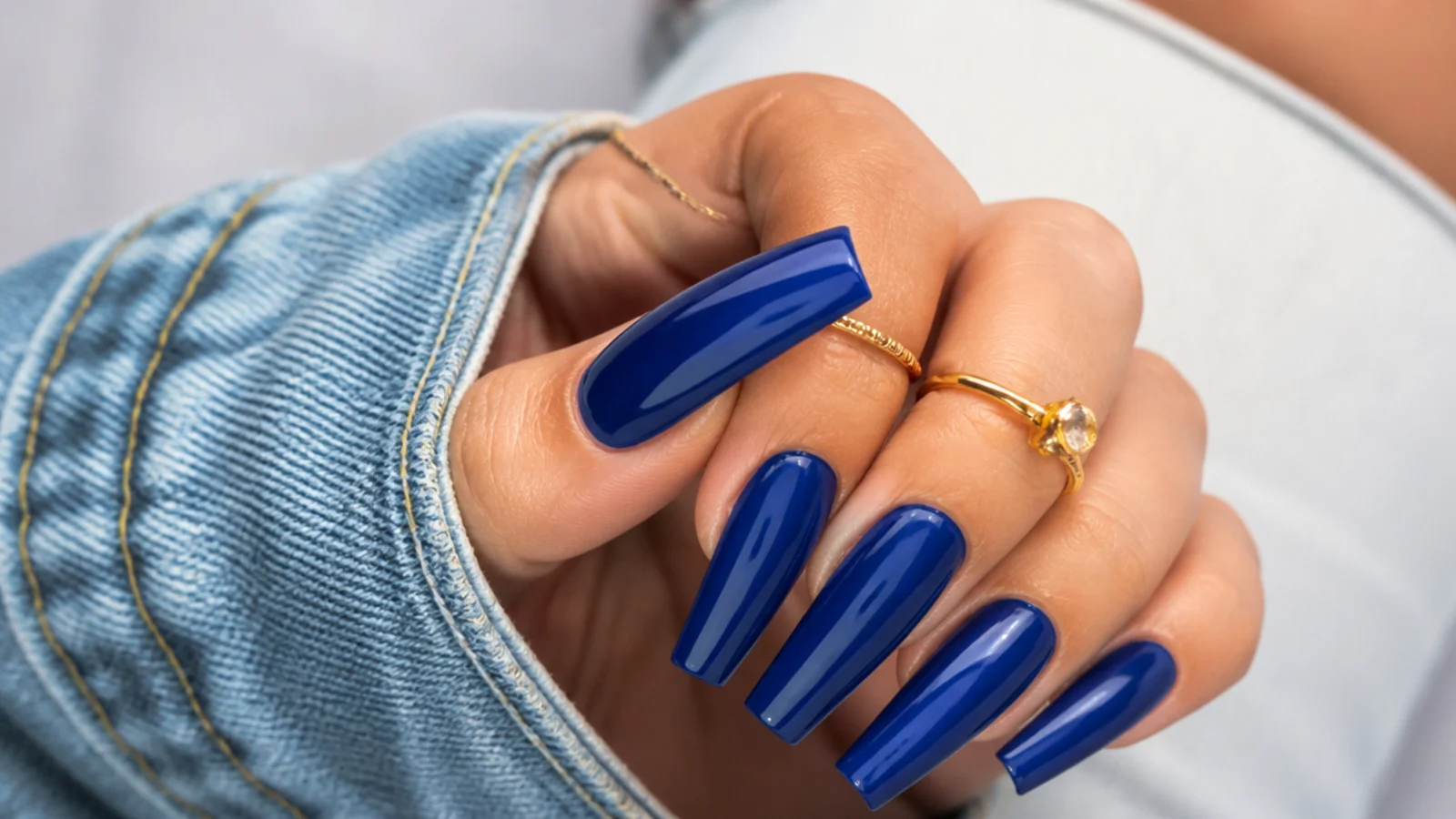 Long royal blue coffin nails with a bold glossy finish