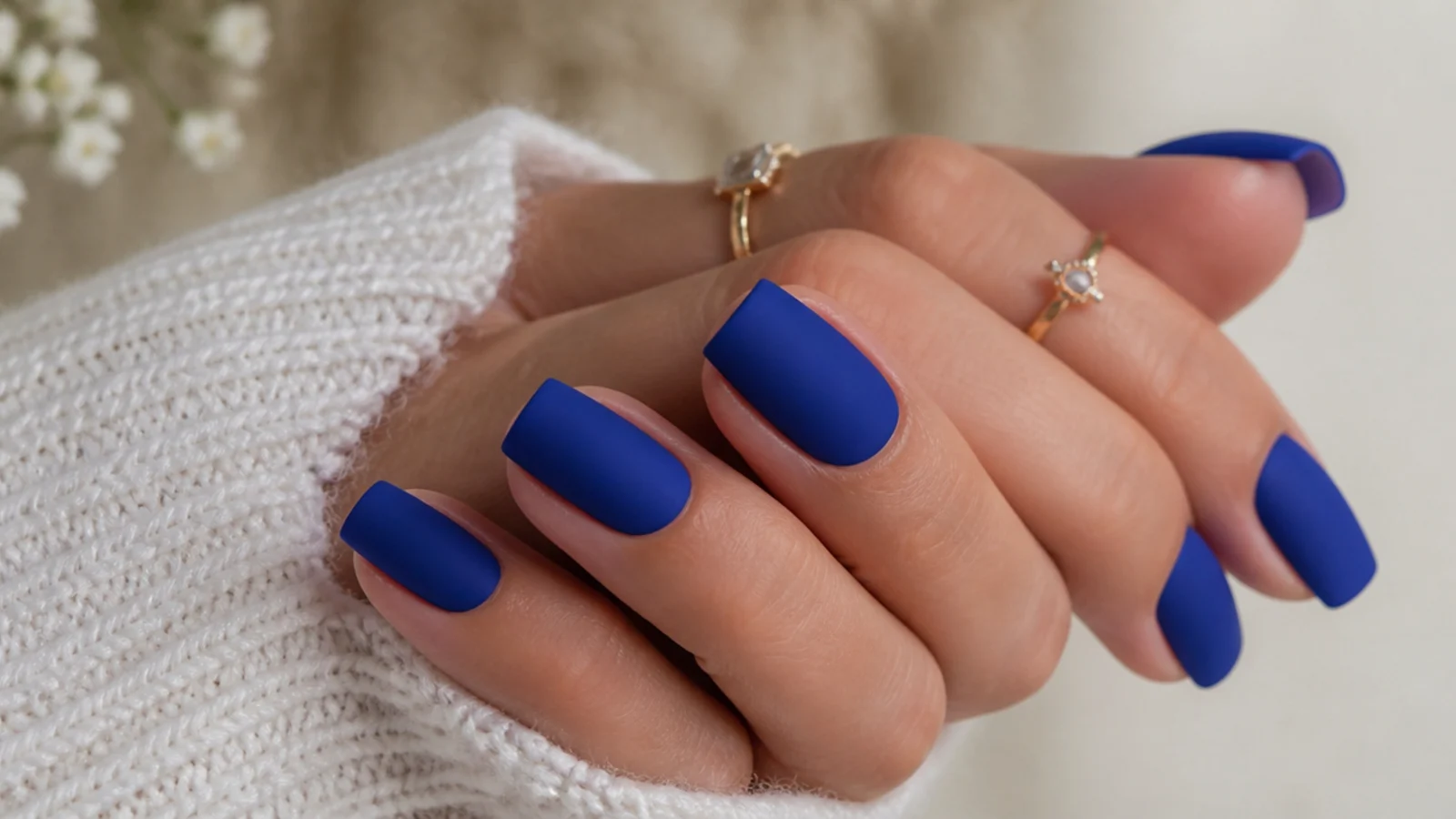 Matte royal blue nails with a soft velvet finish on a square shape