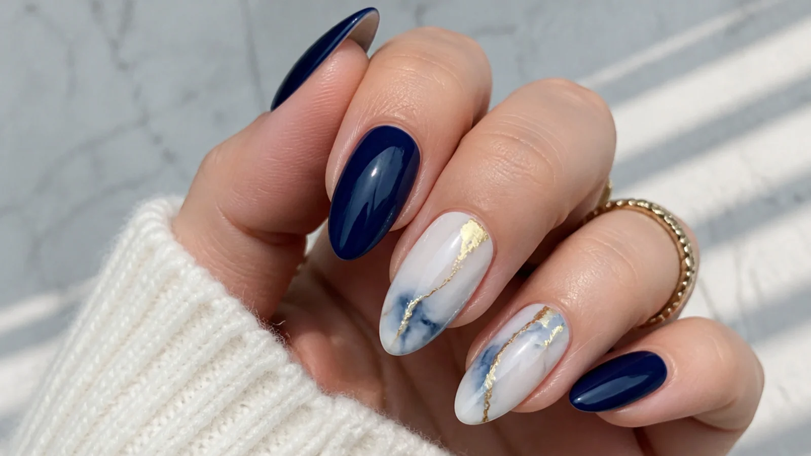 Royal blue and white marble nails with gold vein accents