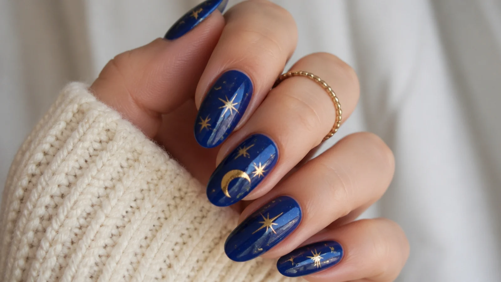 Royal blue nails with gold star and moon celestial accents