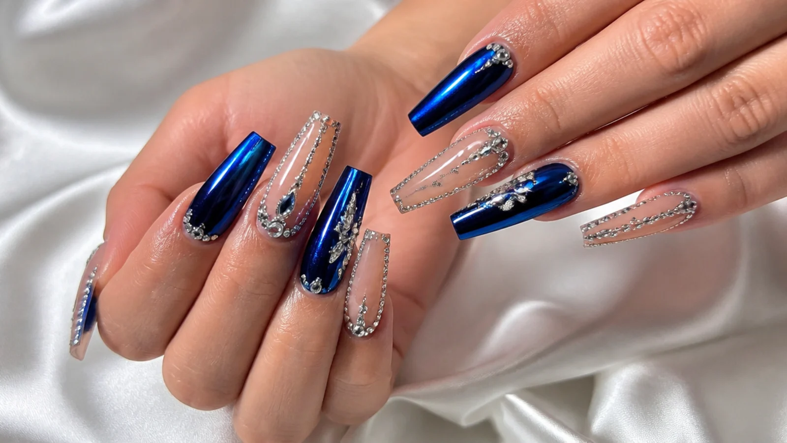 Long royal blue coffin nails with silver rhinestones and chrome accents