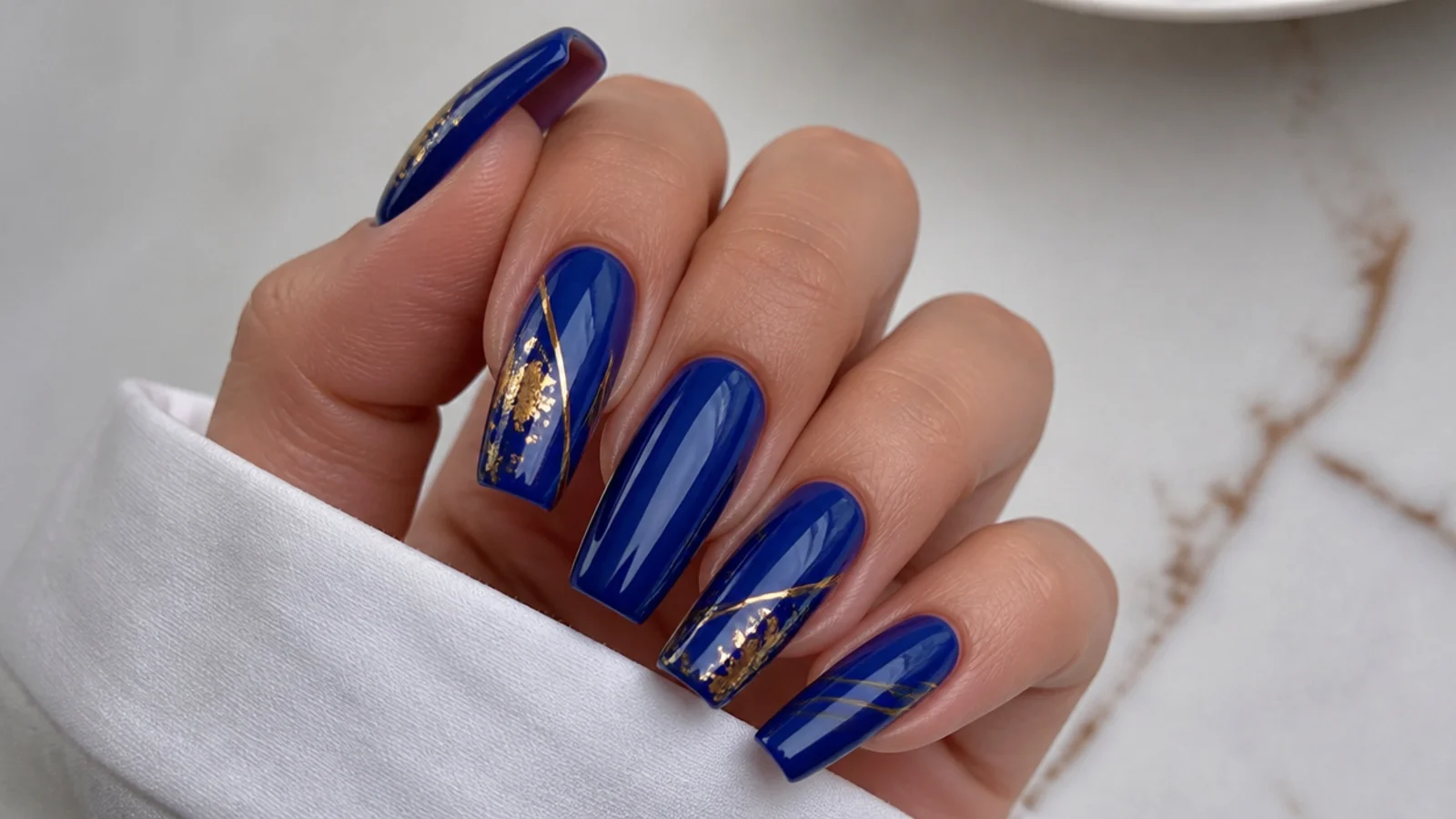 Coffin nails in royal blue with gold foil and thin gold line accents