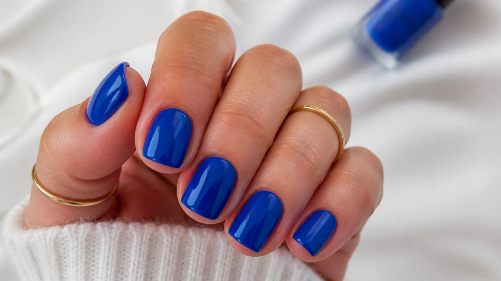 Short squoval nails in solid glossy royal blue on natural-length nails