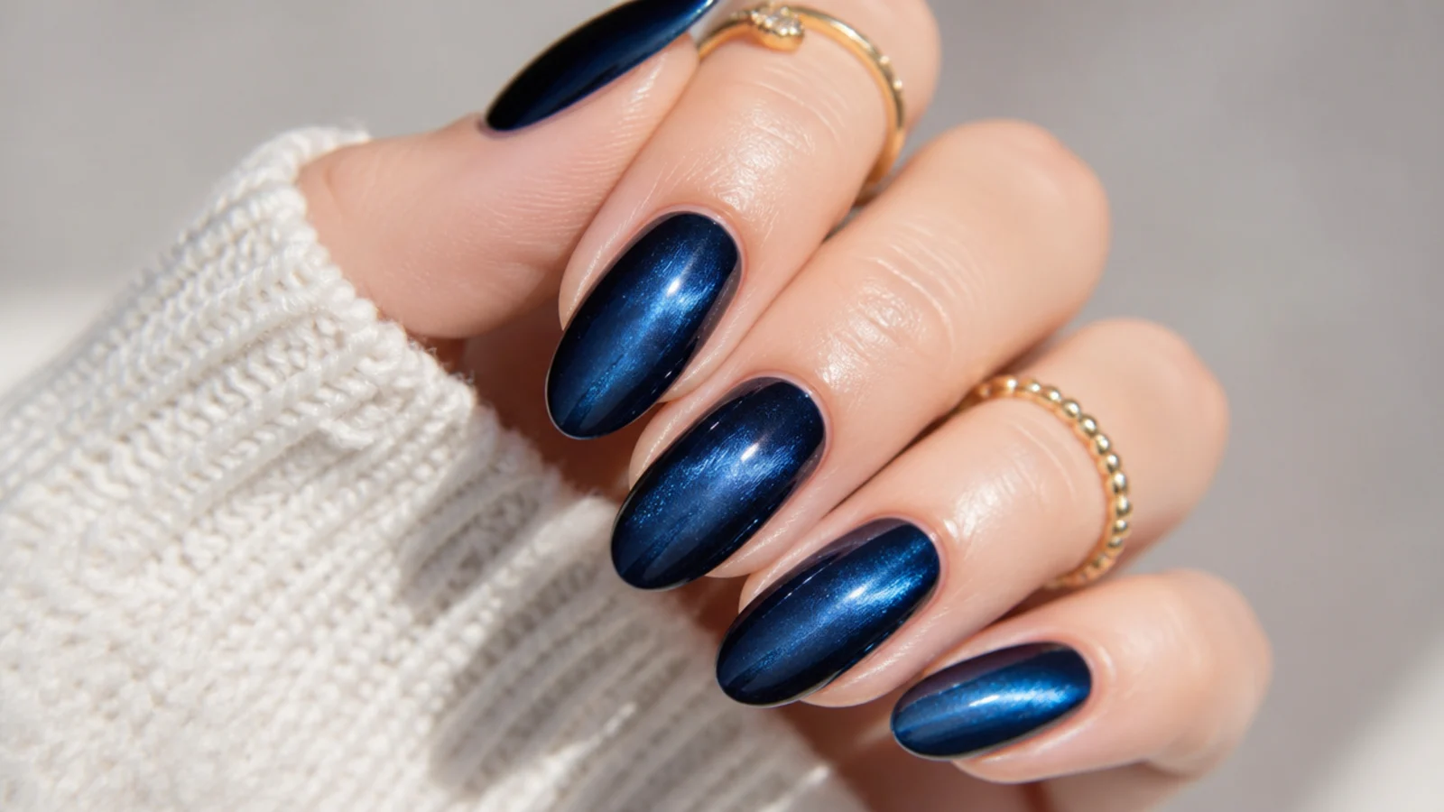 Almond nails in deep royal blue velvet cat-eye with a soft brushed sheen