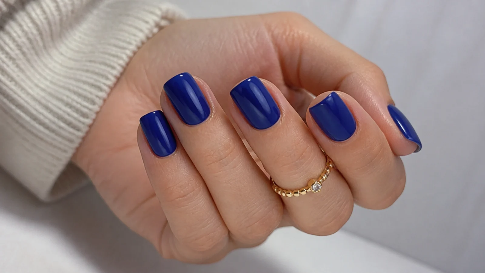 Short royal blue squoval nails in a glossy everyday finish