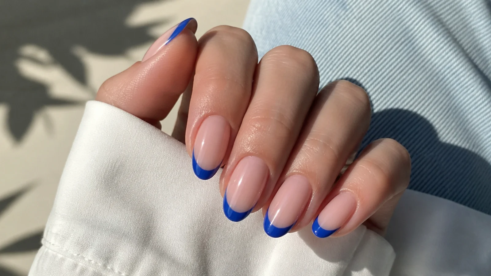 Nude nails with royal blue french tips on a natural base