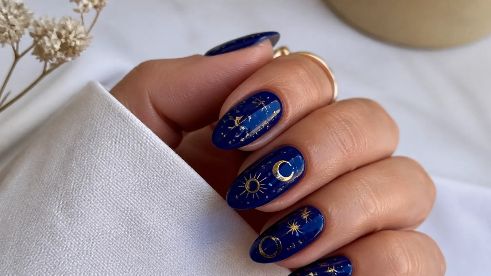 Deep royal blue nails with tiny gold star and celestial accents