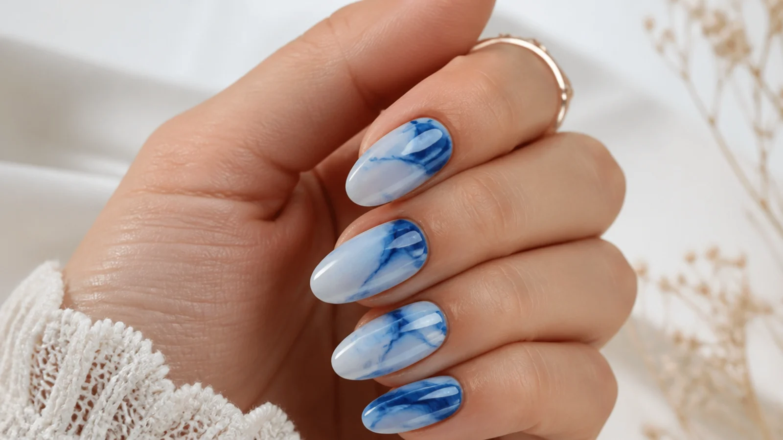 Royal blue and white ink marble nails with soft veined swirls
