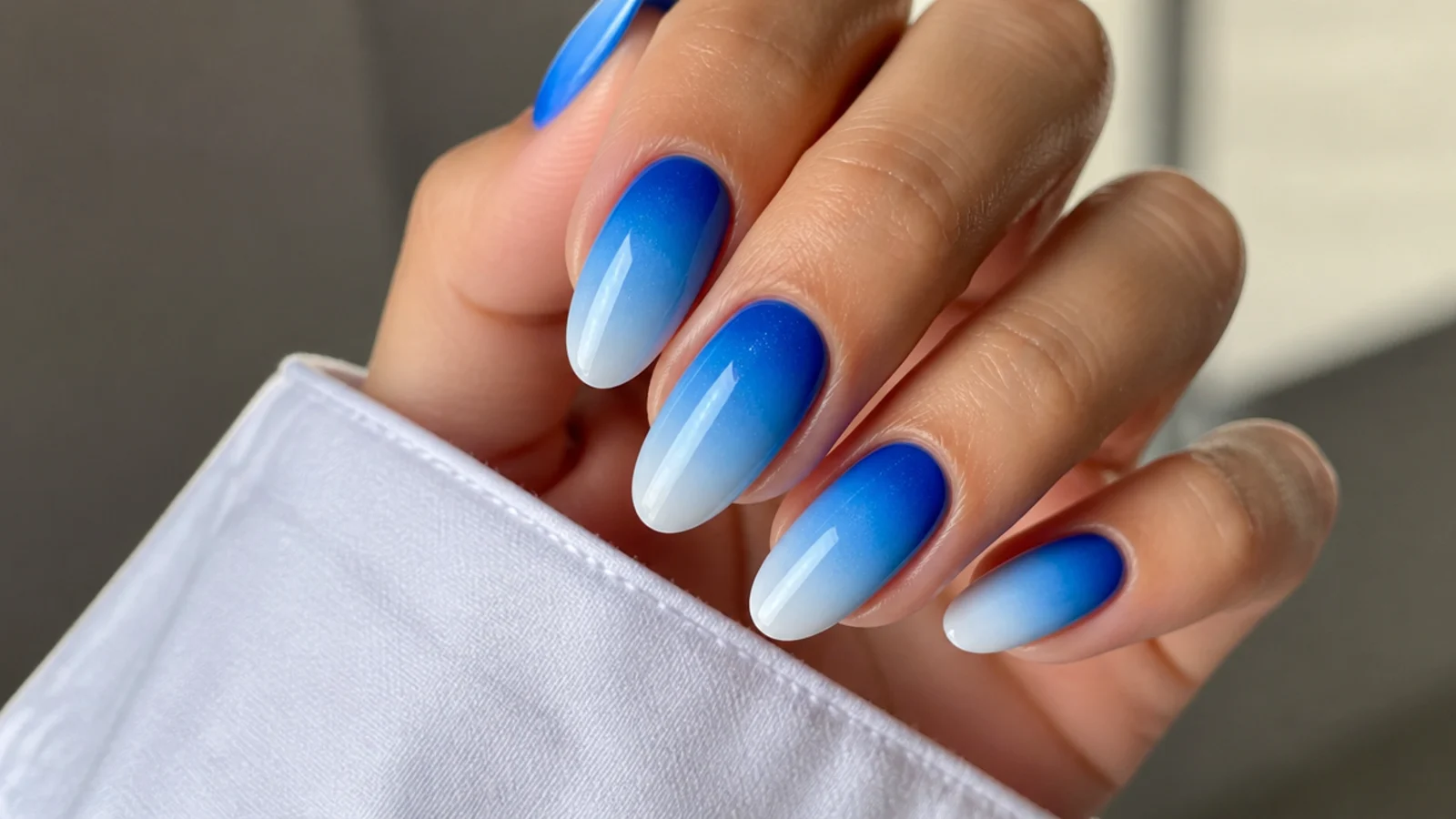 Royal blue nails fading into sky blue then white in a gradient