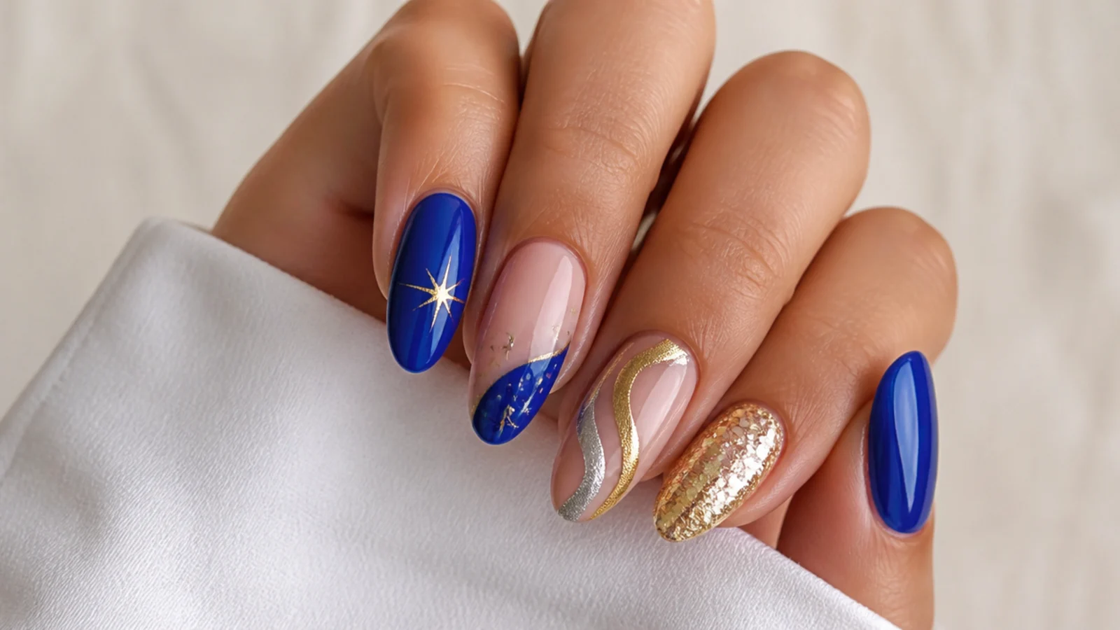 Royal blue nails paired with gold, silver, white and nude accents