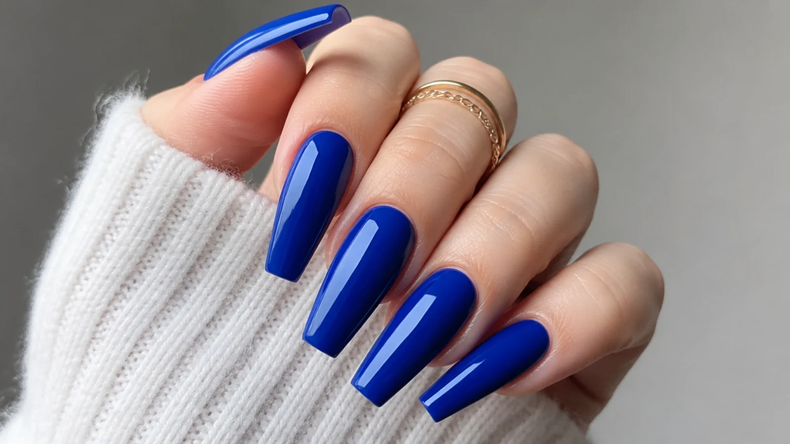 Long royal blue coffin nails with a bold glossy finish