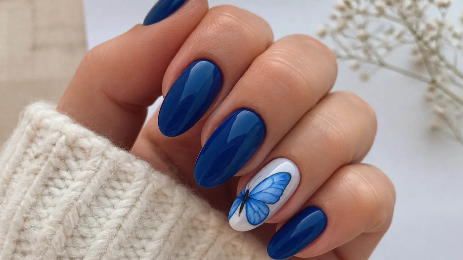 Royal blue nails with a delicate hand-painted butterfly accent nail