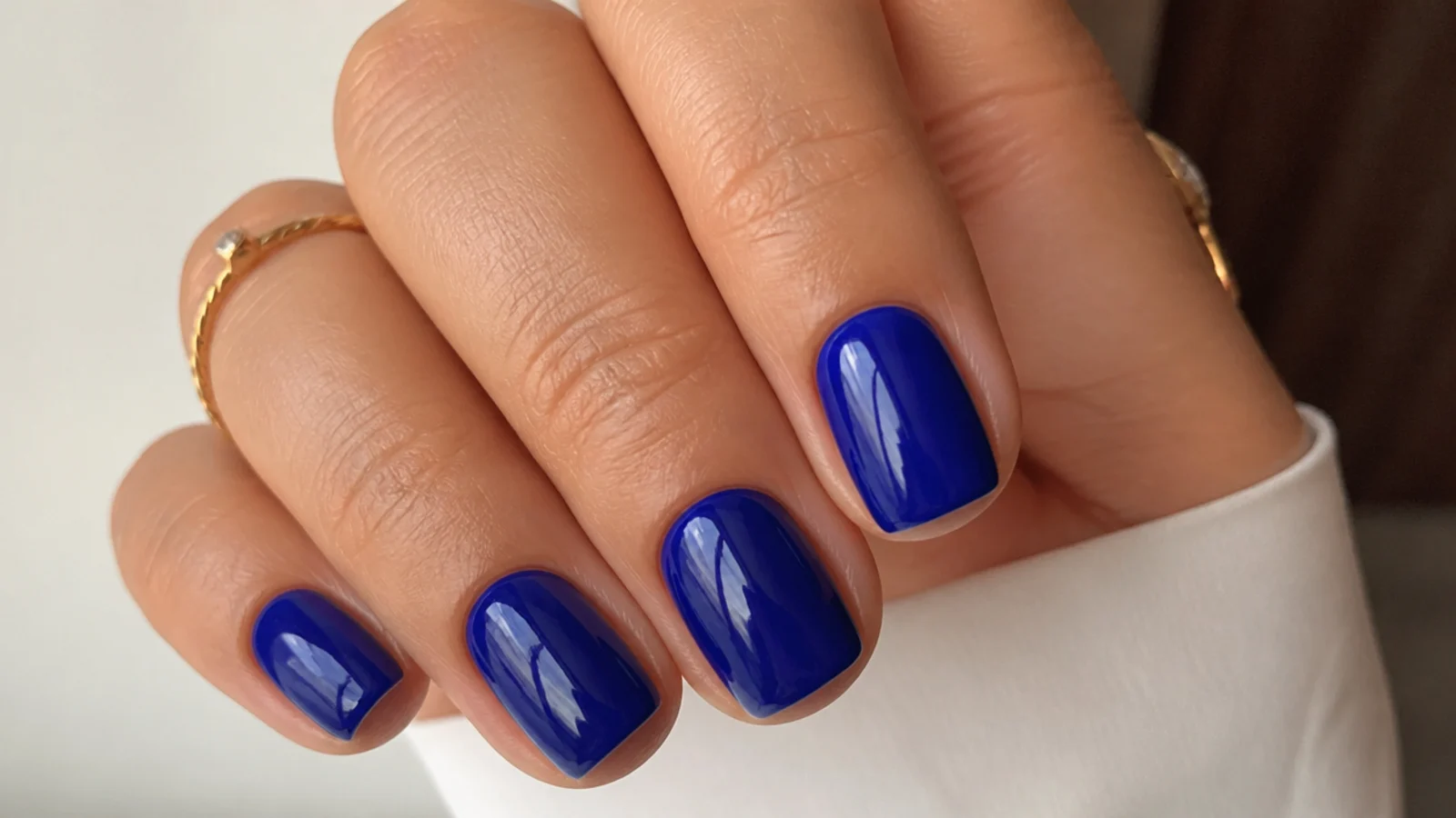 Short royal blue squoval nails with a clean glossy finish